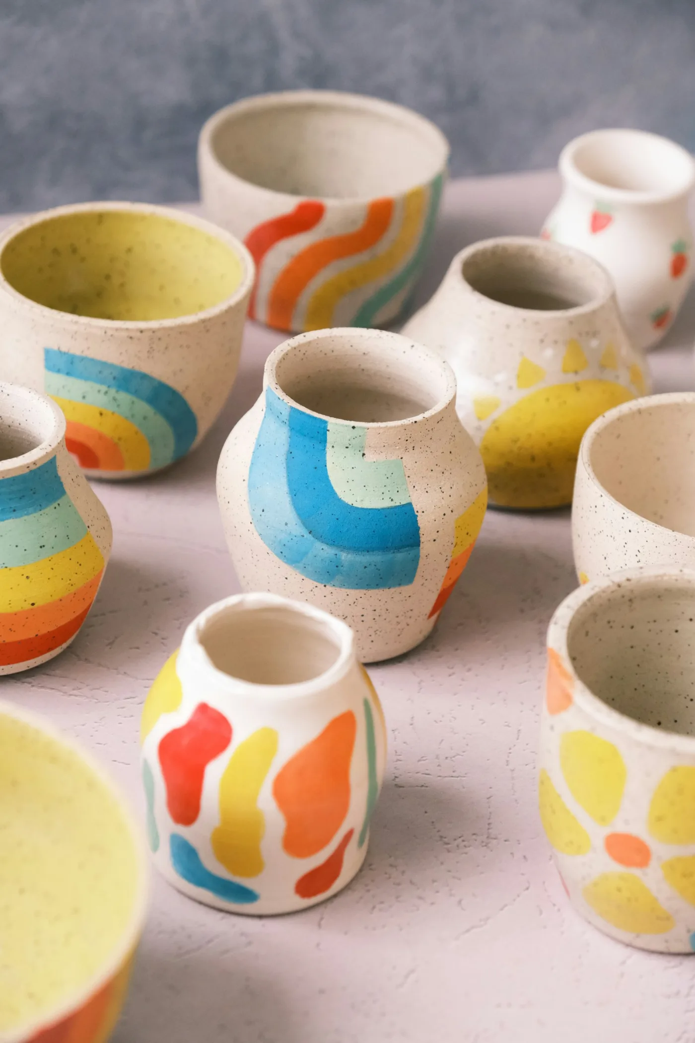 Handmade stoneware ceramic kitchen goods on a sunlit wood counter