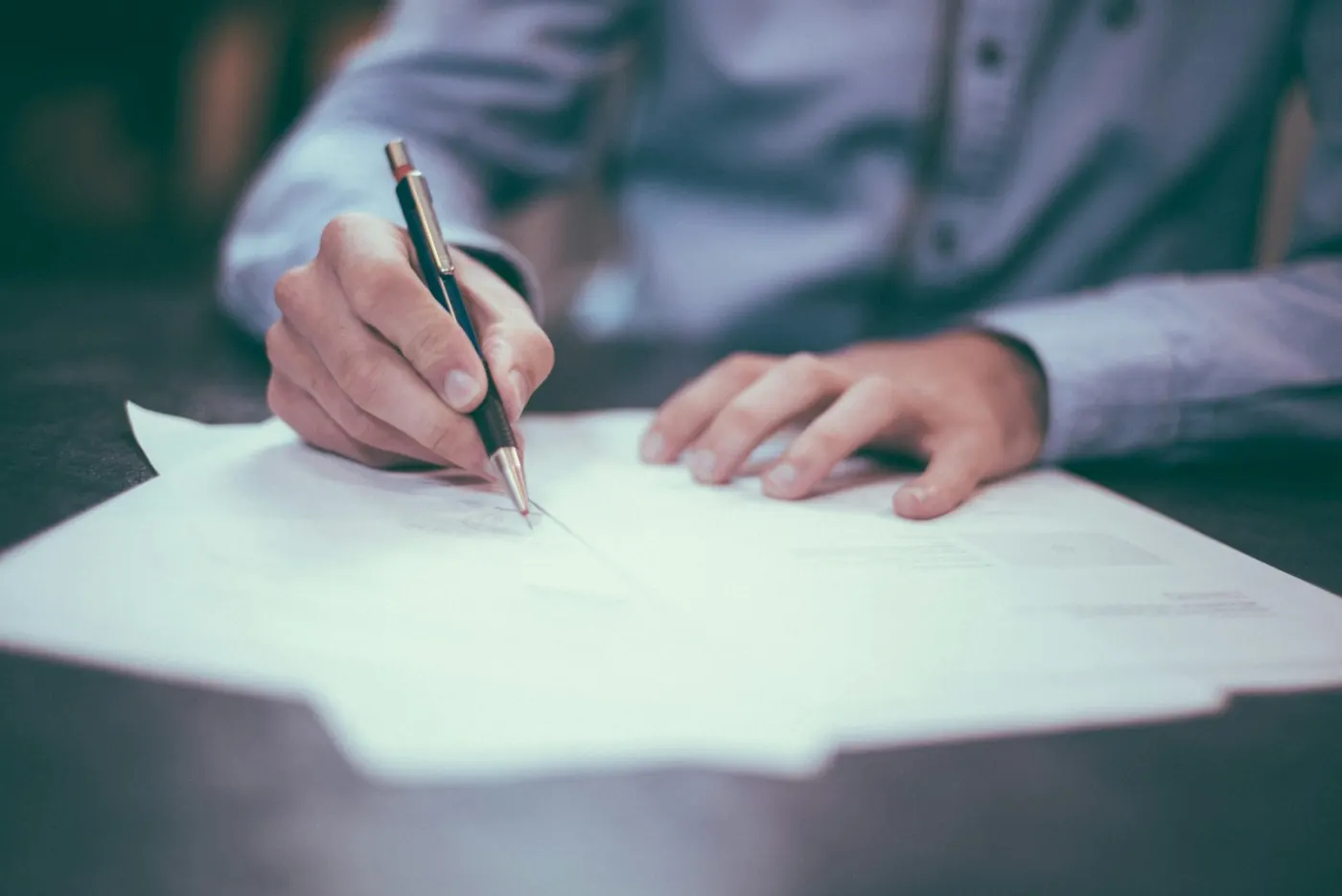 Alder & Quinn partners reviewing financial statements with business client