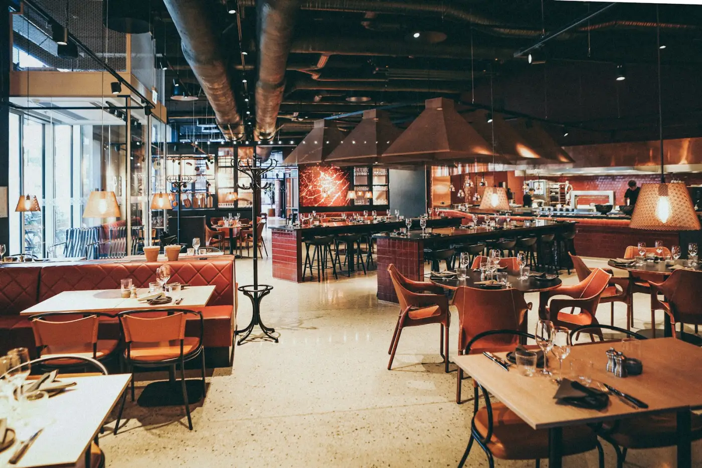 Warm ambient dining room at Mesa Nueve with glowing white oak fireplace hearth and cast iron tables